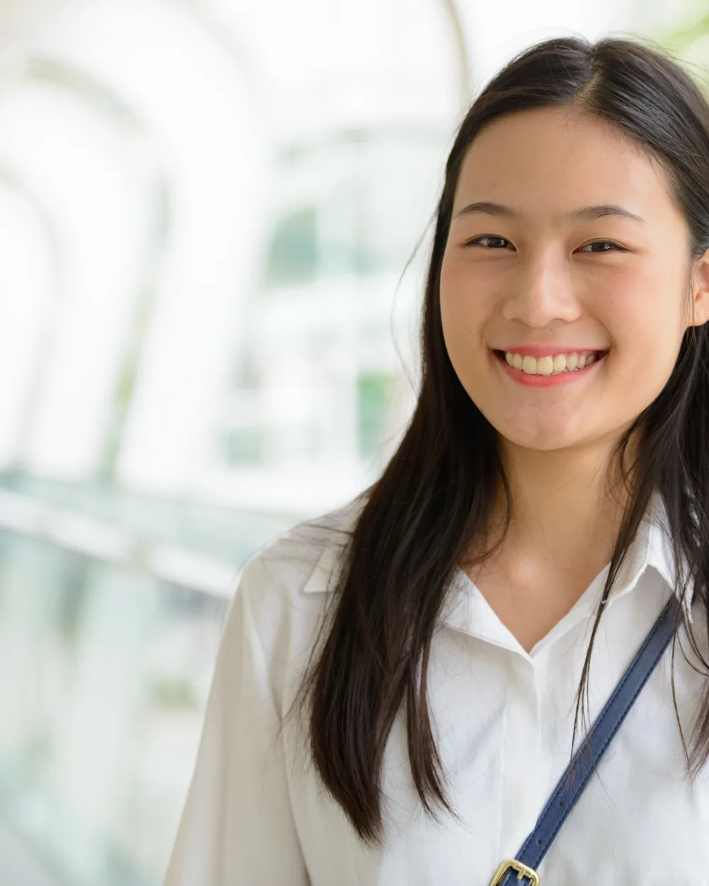 Smiling woman in a white top indoors