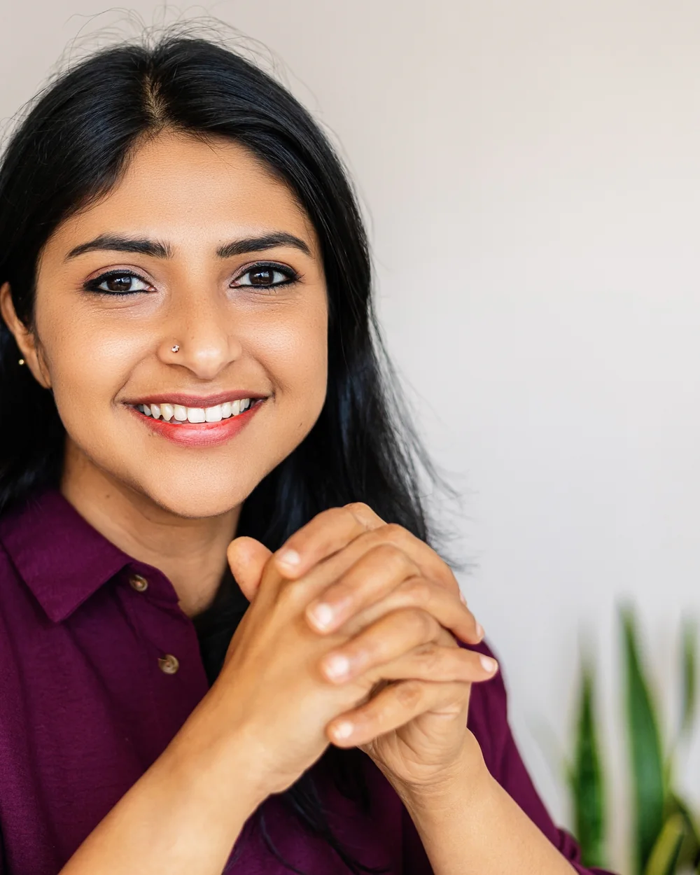 Smiling woman in a purple shirt showing her smile