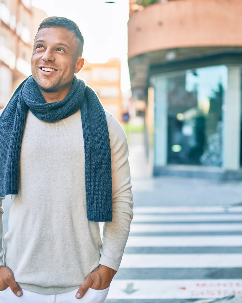 Smiling man standing on a city street