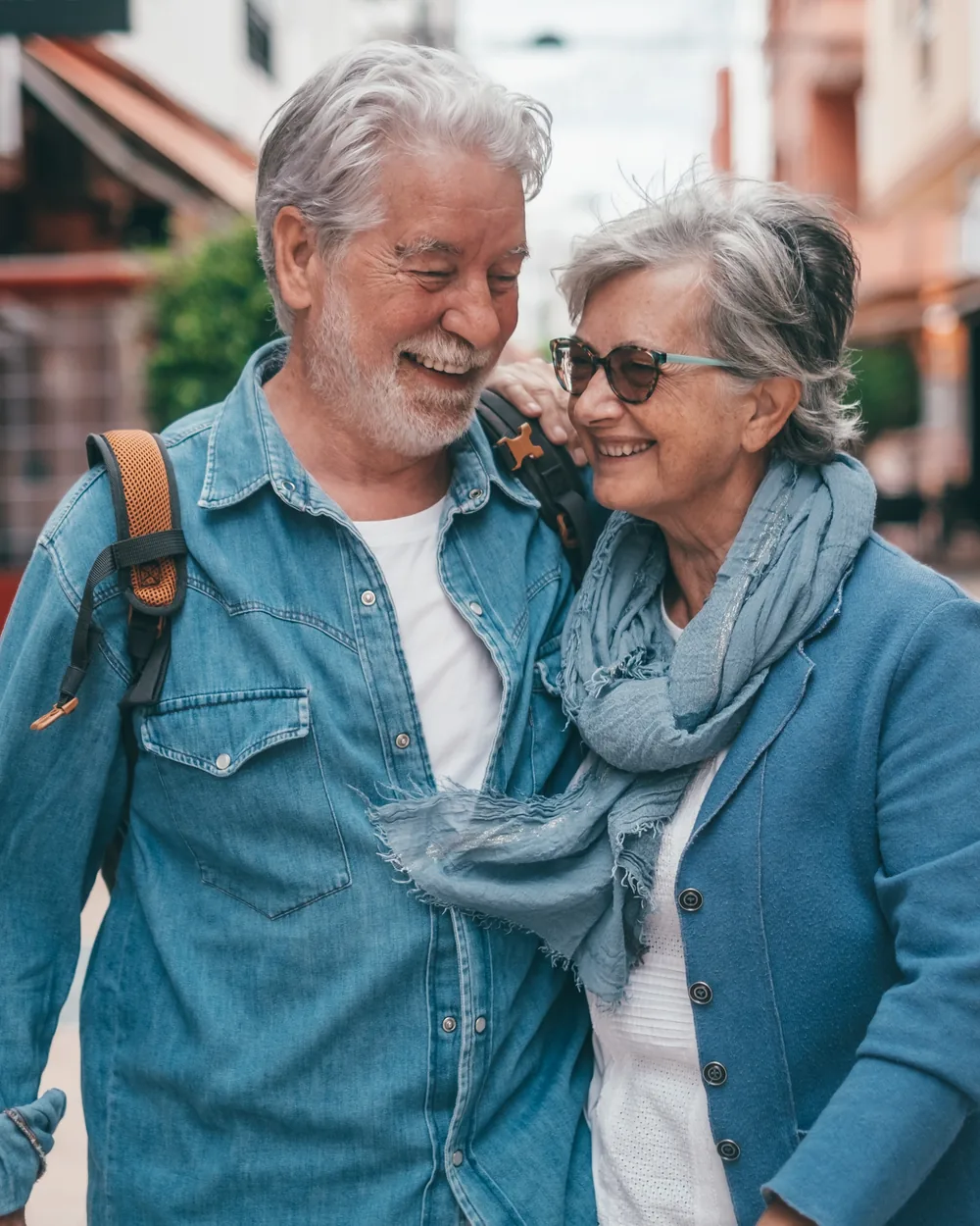 Smiling older couple walking together downtown