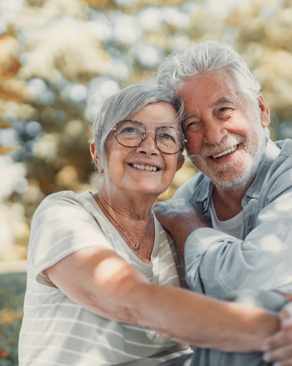 Smiling older couple embracing outdoors