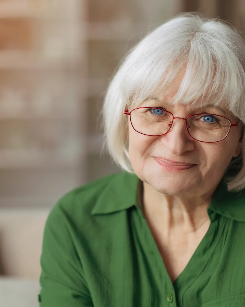 Smiling older woman in glasses at home
