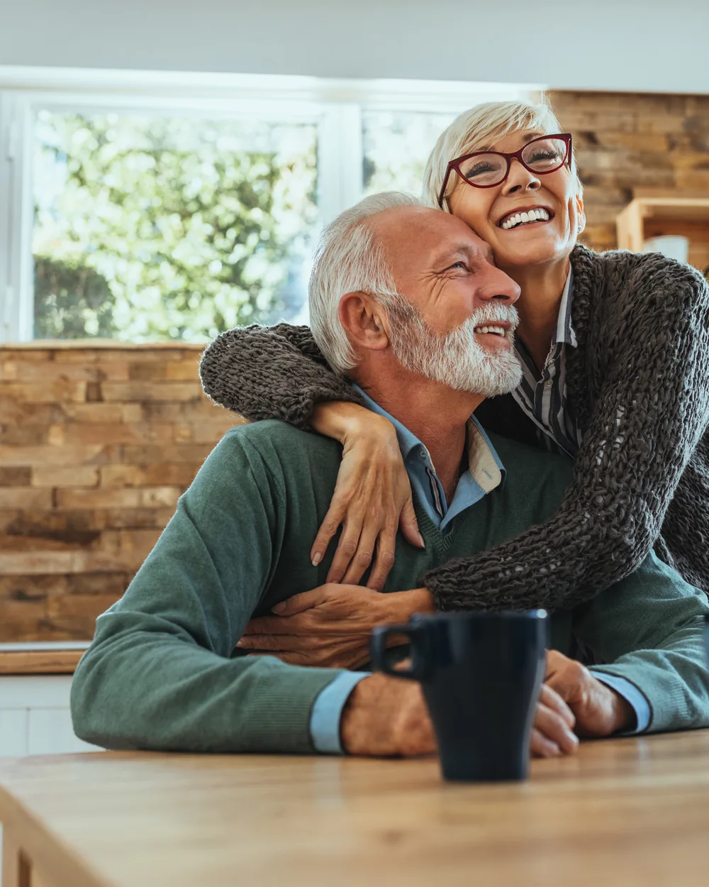 Smiling older couple seated together at home