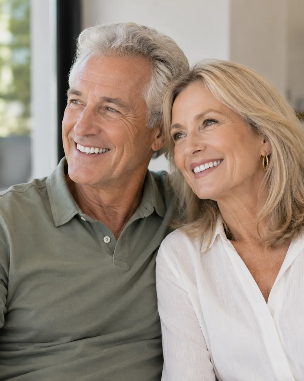 Smiling older couple seated together at home