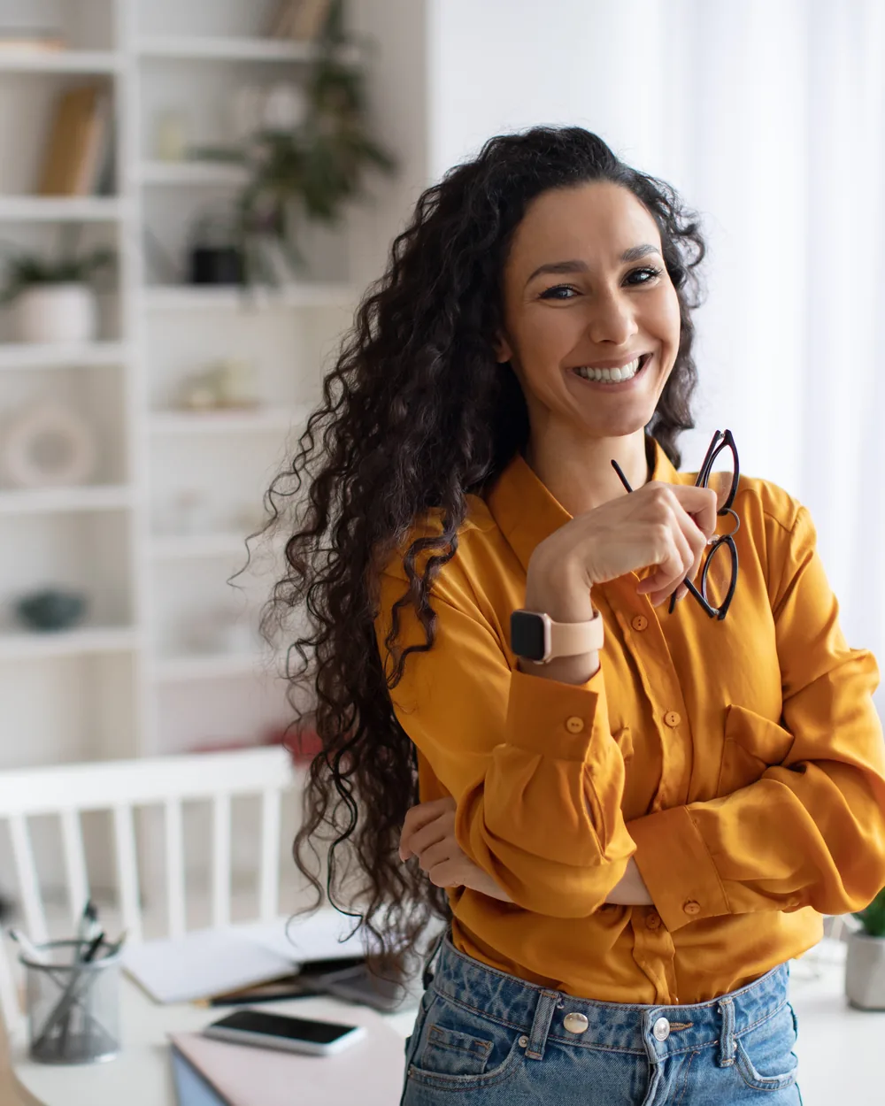 Smiling woman in a yellow sweater at home