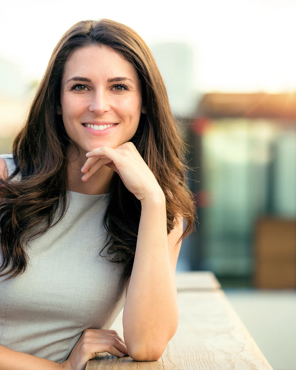 Woman resting her chin in her hand outdoors