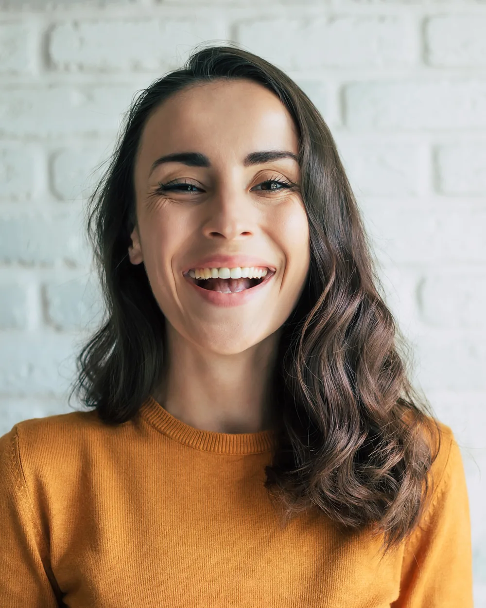 Smiling woman in a mustard sweater