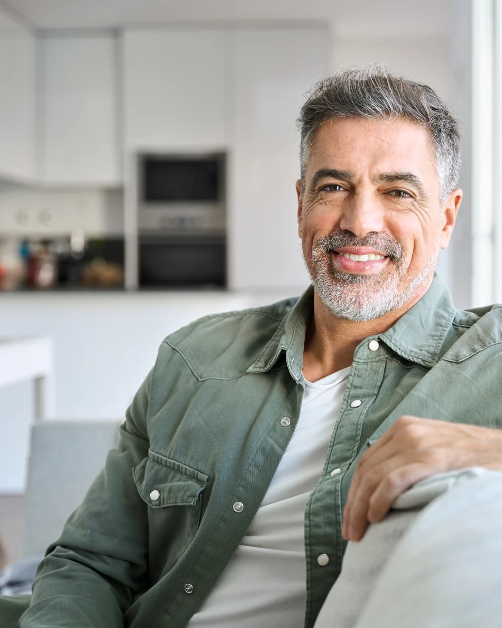 Relaxed adult patient seated in a bright home setting