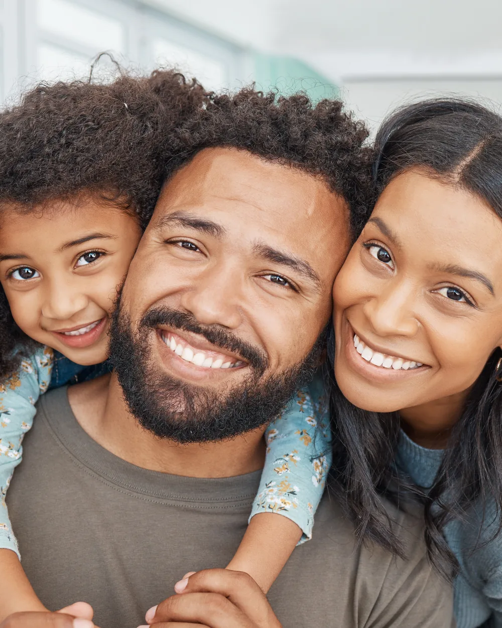 Smiling family together in a bright home setting