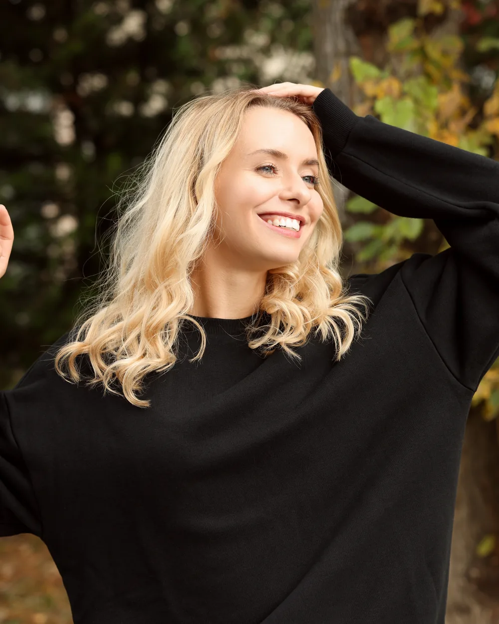 Smiling woman outdoors in a black sweater