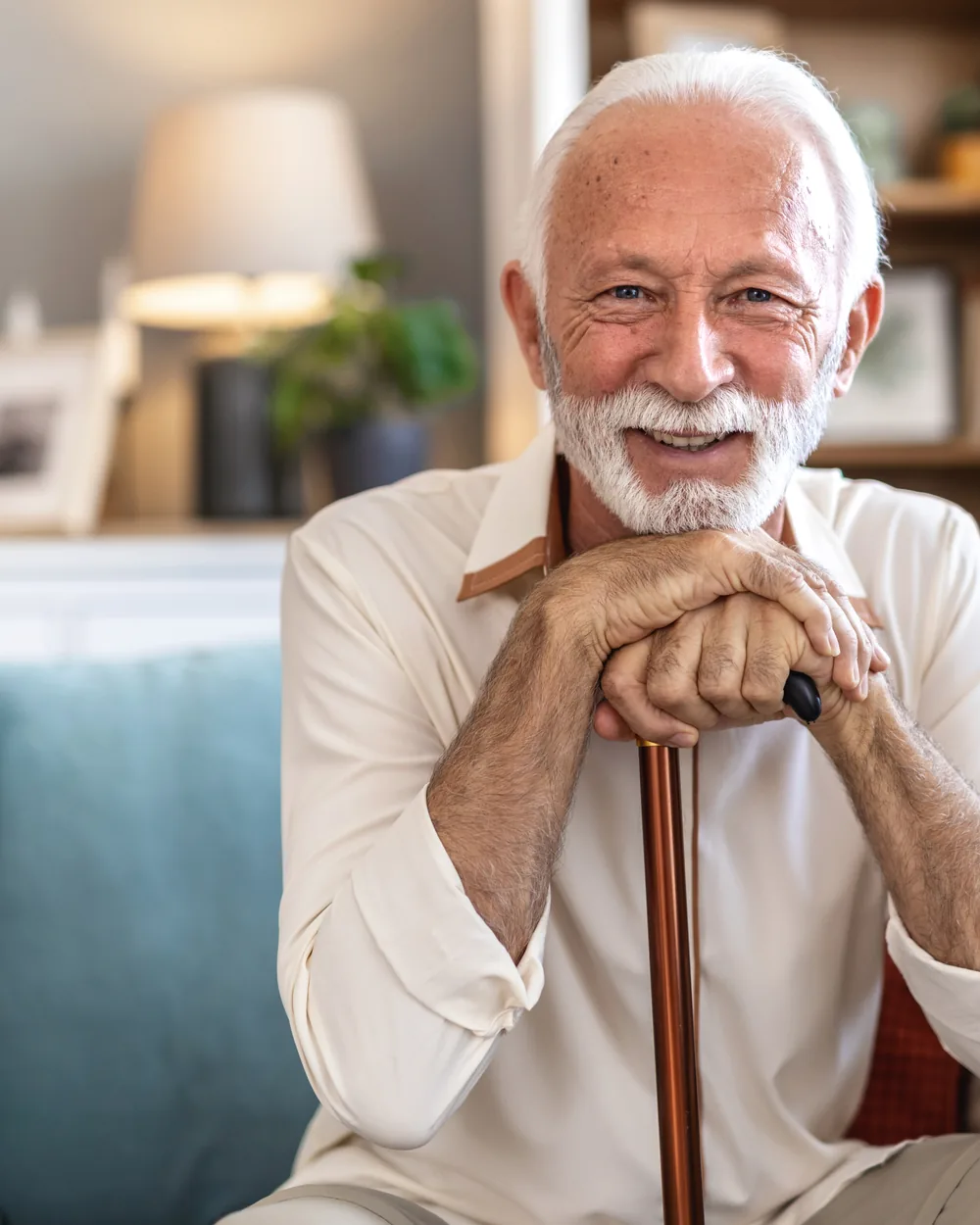 Smiling older man seated in a comfortable home setting