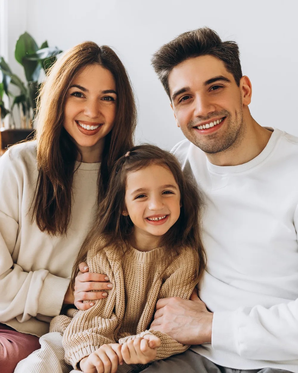 Smiling family seated together at home