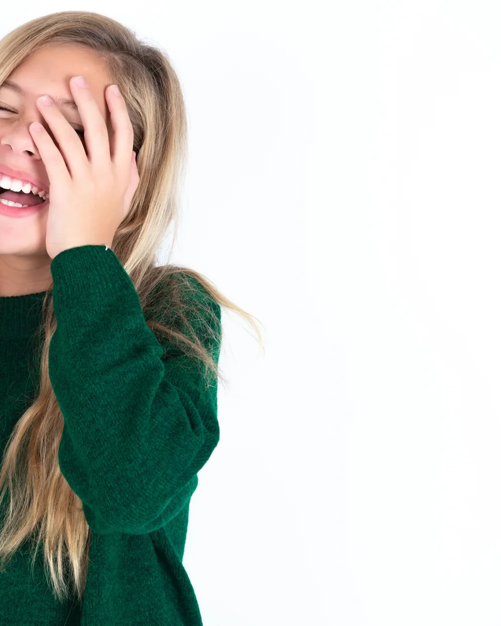 Smiling child in a green sweater