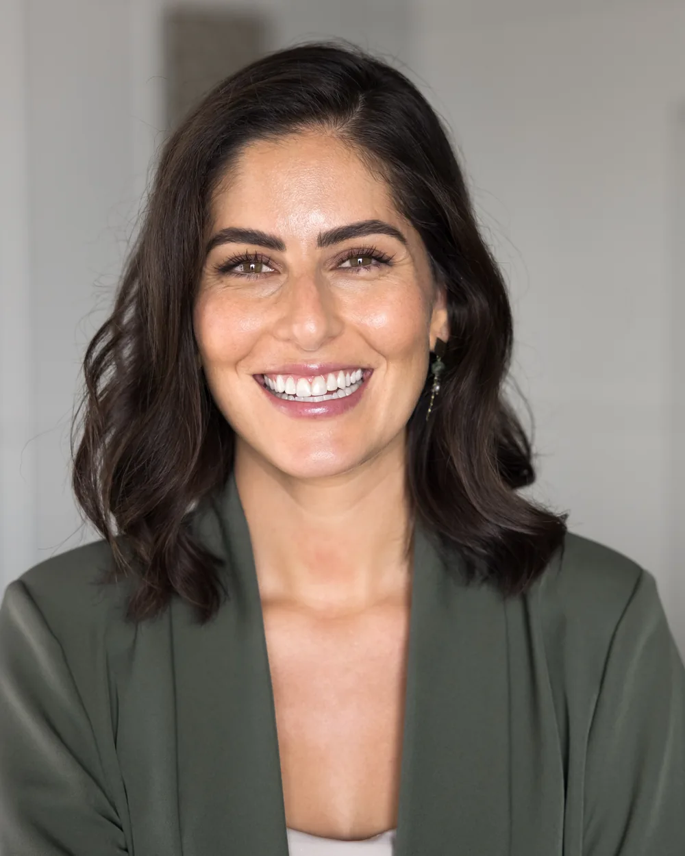 Smiling woman in a green blazer
