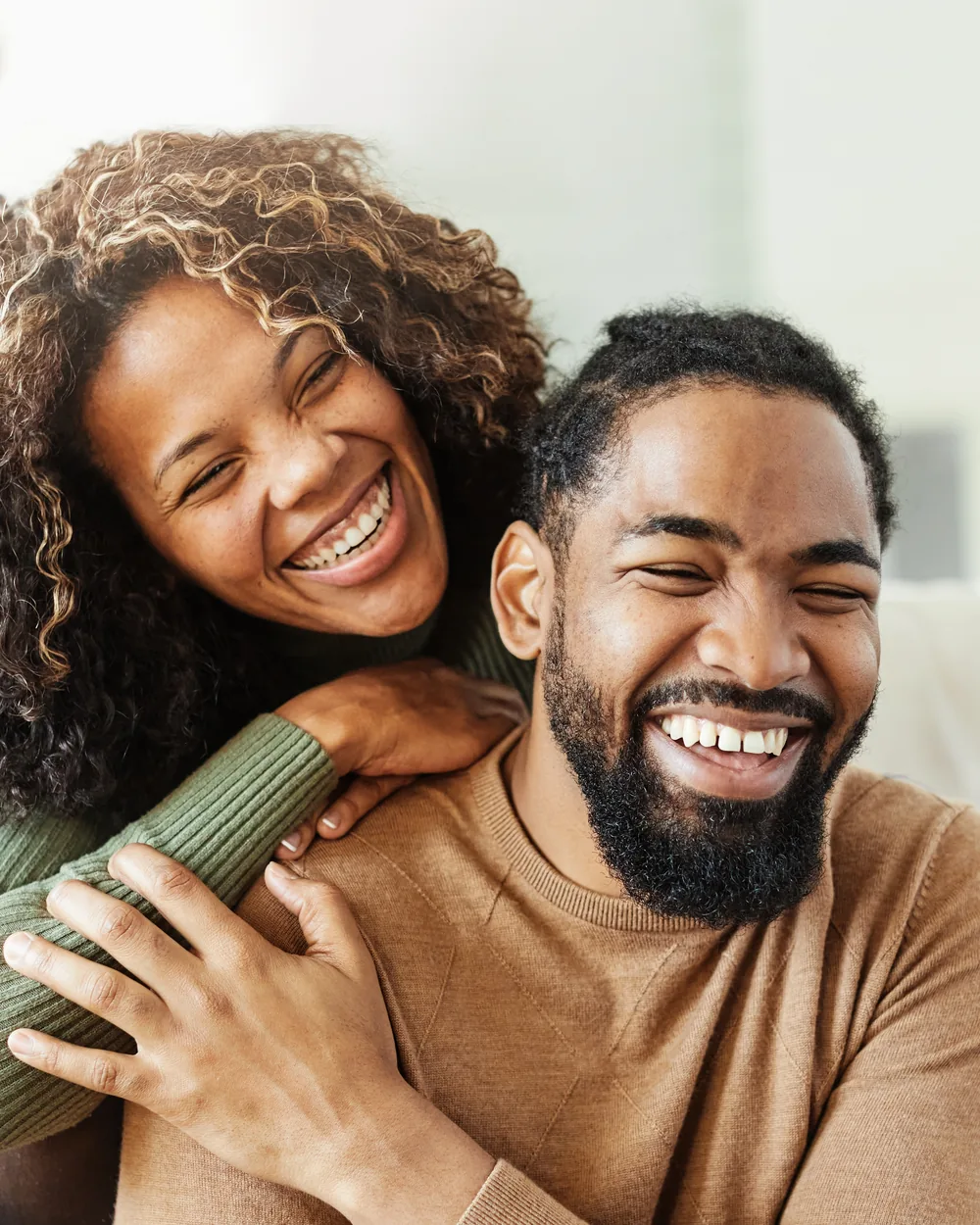 Smiling couple relaxing together at home