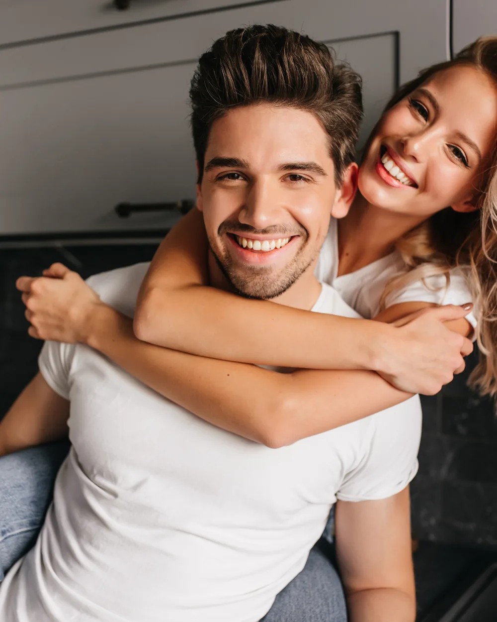 Smiling young couple together in a bright home