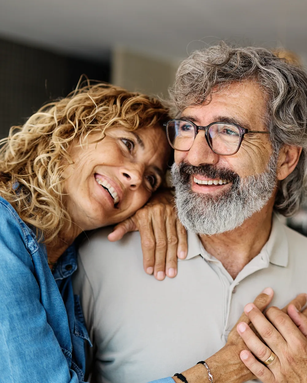 Smiling couple seated together at home