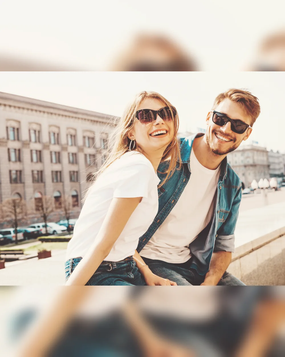 Two young adults smiling together outdoors